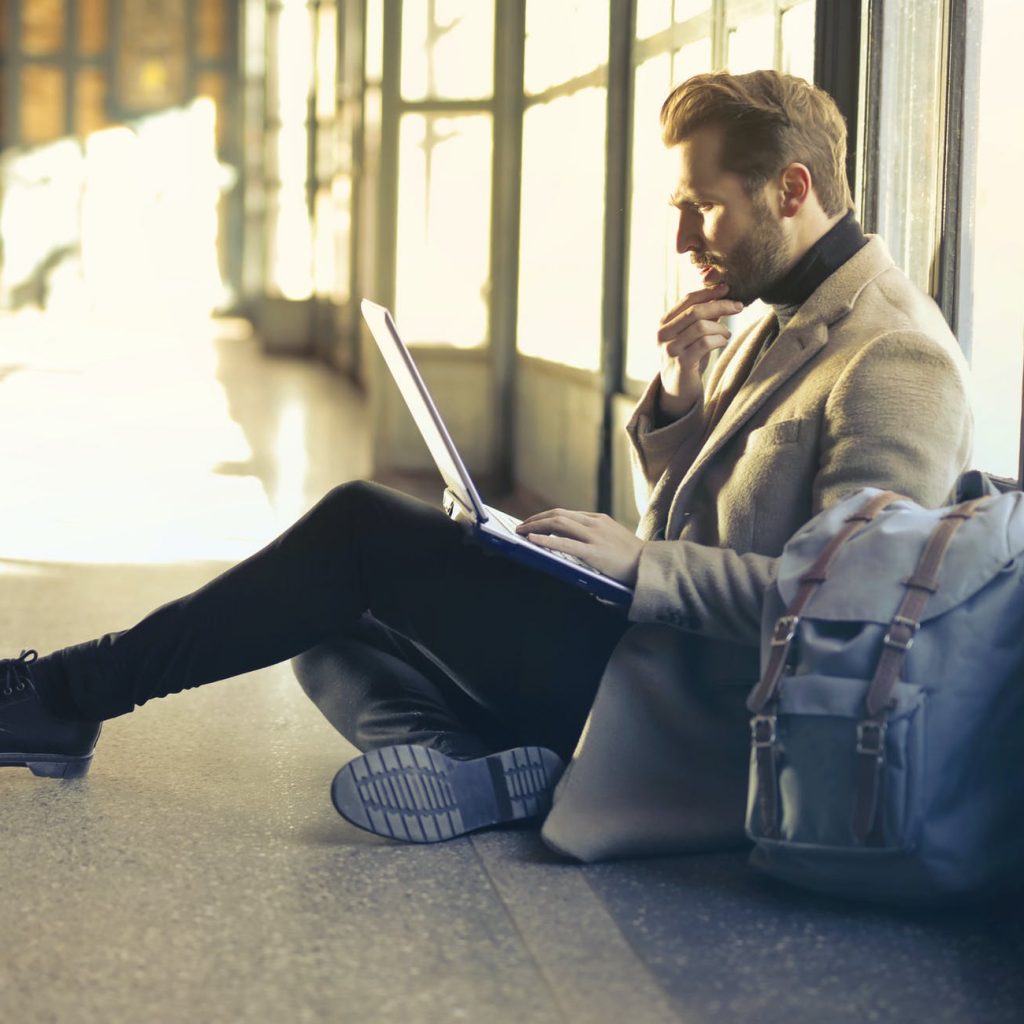 brown haired man using laptop computer